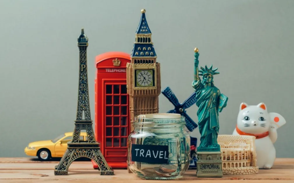 Travel souvenir miniatures including the Eiffel Tower, Big Ben, Statue of Liberty and a lucky cat